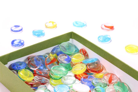 Colorful glass marbles in a box on white background, close upの写真素材