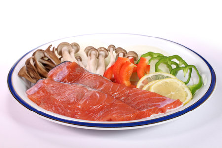 Cooking image, foil grilled 
ingredients. 
salmon and vegetables on a plate.の写真素材