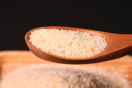 Bread crumbs on a wooden tray and a wooden spoon, close upの写真素材
