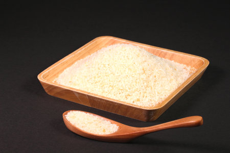 Bread crumbs on a wooden tray and a wooden spoon, close up