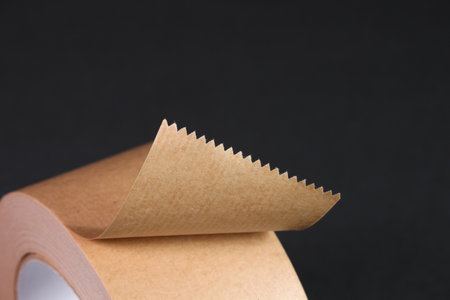 Roll of brown adhesive tape on black background, close upの写真素材