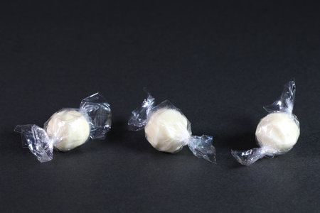 Three pieces candy cheese on black backgroundの写真素材