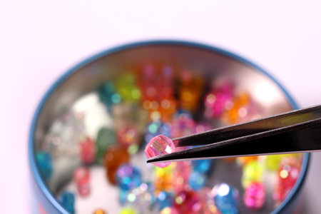 Tweezers and beads in a canの写真素材