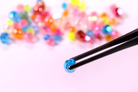 tweezers and beads, close upの写真素材
