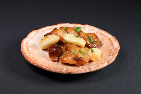 Garlic chicken on a plate on black backgroundの写真素材