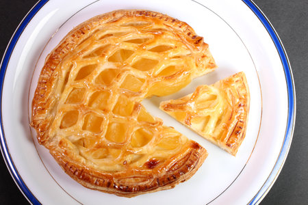 Apple pie on a plate on black background, top viewの写真素材