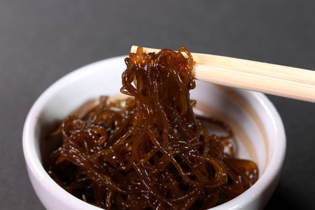 Eating Mozuku with chopsticks, close upの写真素材