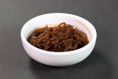 Mozuku in a small bowl on black backgroundの写真素材