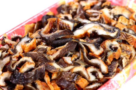 chopped conger eel kabayaki in a food tray, close upの写真素材