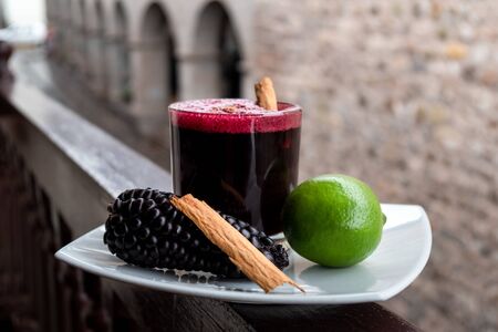 Chicha morada. Peruvian drink, decorated with lime, a piece of cinnamon and chicha fruitの写真素材