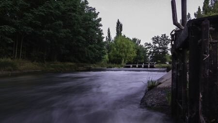 Stream of water flowing through irrigation. There are floodgates that allow and obstruct water. Water silk effectの写真素材