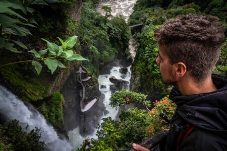 R?o Verde waterfall or also called Pail?n del Diablo waterfall. A tourist who contemplates the incredible and powerful waterfall surrounded by a tropical forest. You can see its emblematic staircase. Ecuadorの写真素材