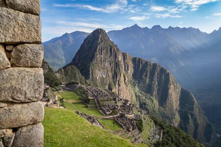 Photography of Machu Picchu ruins taken behind a great wall made of stone. Peruの写真素材
