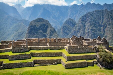 Photography taken from Machu Picchu ruins where big walls made of stones can be appreciated. Behind, big and beautiful mountains. Peru.の写真素材