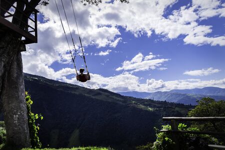 Woman on the swing of the end of the world in Ba? ? os, Ambato. The tree house, Ecuador, Latin Americaの写真素材