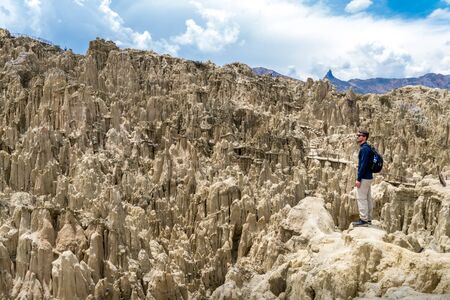 A tourist staring at the landscape of the Moon Valley in La Paz, Boliviaの写真素材