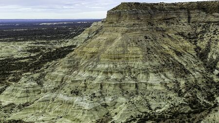 Huge arid and colorful mountain, small bushes in place. Wind erosion is notable in the mountains. Argentine Patagoniaの写真素材