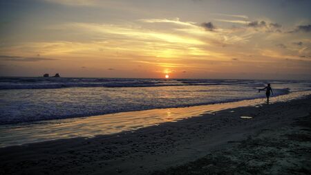 Amazing sunset at the beach. Ocean waves, sand can be seen. Latin Americaの写真素材
