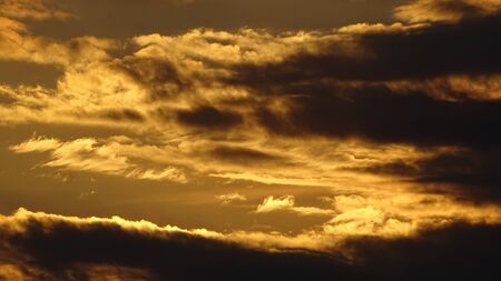 Sky full of clouds with some sun rays. Heaven sky. Background photographyの写真素材
