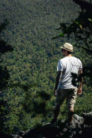 Young man in the middle of the forest admiring nature. Travel concept.の写真素材