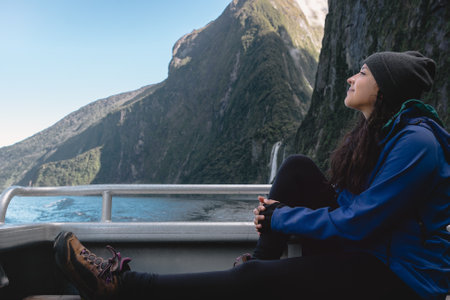 Brunette woman enjoying trip in Milford Sound Cruise. Fiordland National Park, New Zealand.の写真素材