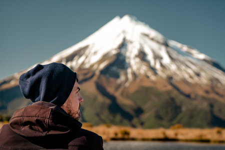Young man profile with spectacular view of snowy peak behind. Copy spaceの写真素材