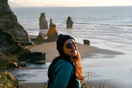 Woman looking at the camera on beautiful seaside landscape.の写真素材