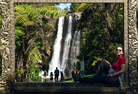 Woman sitting on golden frame in Hunua Falls. September 2020, Auckland Region, New Zealand.のeditorial素材