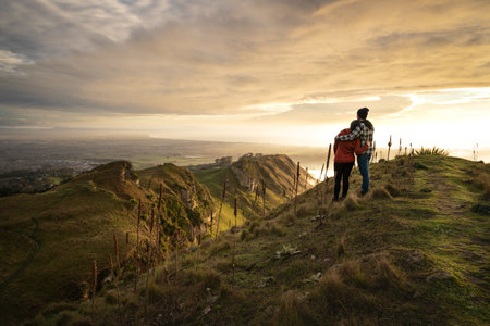 Couple embracing each other on the peak on a mountain. Landscape photography, travel conceptの写真素材