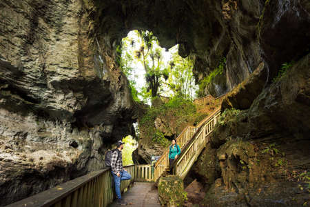 Couple hanging around Mangapohue Natural Bridge, located in Waikato, New Zealand.の写真素材