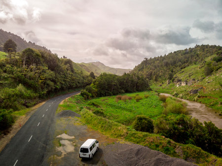 White van parked by the road in the middle of the forest. Aerial viewの写真素材