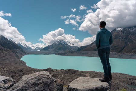 Young man on Tasman Lake viewpoint. Aoraki, Mount Cook National Park. New Zealand