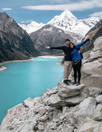 Young couple enjoying and smiling in Laguna Paron, Peru. Vertical photographyの写真素材