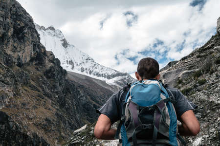 Man with backpack hiking in snow mountain. Huascaran National Park, Peru. Copy spaceの写真素材