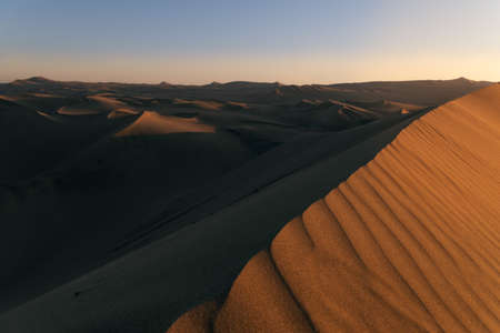 Scenic sunset in the desert full of sand dunes. Ica, South America, Peruの写真素材