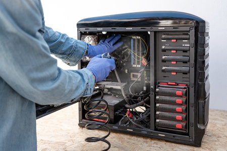 Blowing computer cabinet with air compressor. Computer repair service. close-upの写真素材