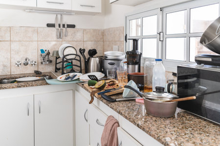Morning chaos in the kitchen full of dirty dishes and rubbish everywhere. close-upの写真素材