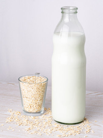 Bottle of fresh oat milk. Non dairy and lactose free concept. portrait photoの写真素材