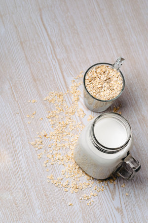 Glass of oat milk and oat grains. Vegan and non-dairy concept. Top view. portrait photographyの写真素材