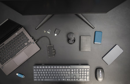 Workstation of program developer. Top view on black mood background. Technological conceptの写真素材