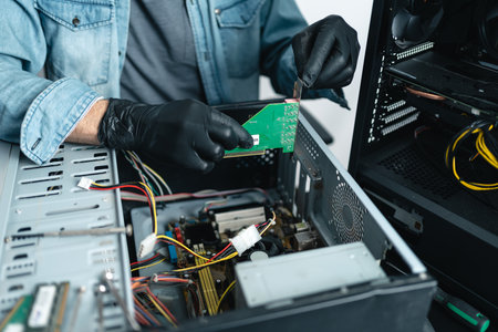 Close up of man hands wearing gloves repairing desktop computer. PC repair service conceptの写真素材
