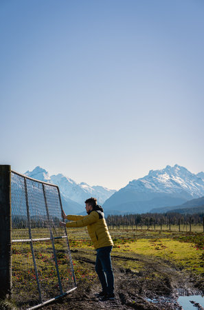 Man pushing bars of farm in the mountainside in winter sunny day. portrait photographyの写真素材