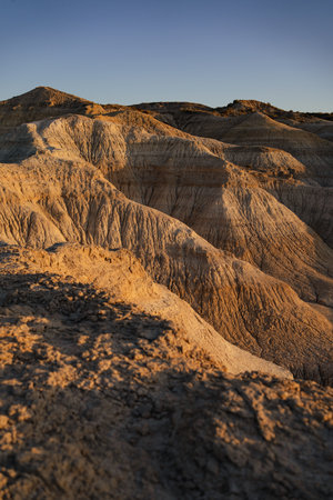 Arid landscape in semi-desert at golden hour during sunset. Vertical photography. General Roca, Rio Negro, Patagonia, Argentinaの写真素材