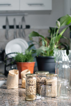 Close video of bulk food in recycled glass jars on the kitchen table. Zero waste and ecological actions at home concept. portrait photographyの写真素材