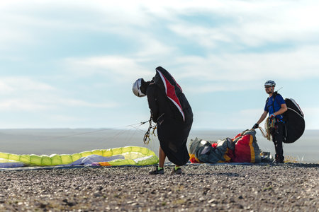 Two paragliders getting ready for taking off above the hill. Copy space on left side for advertisement textの写真素材