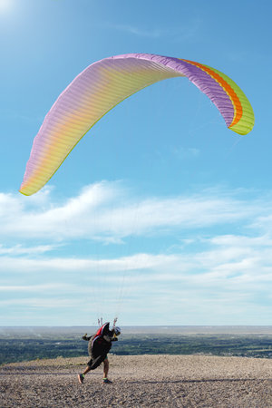 Man running to the risk ready for paragliding flight. portrait photographyの写真素材