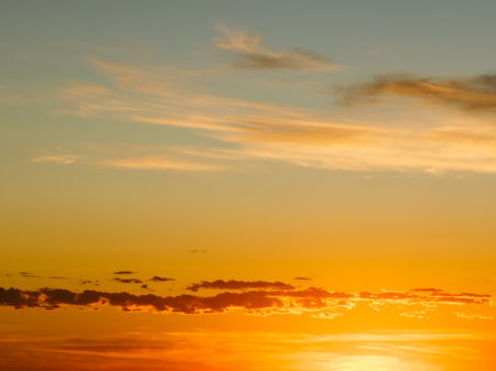 Epic colorful sunset sky with clouds and sun rays during golden hour. Natural sky backgroundの写真素材