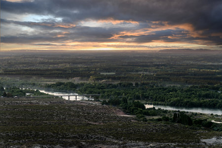 Epic thunderstorm landscape above countryside with river and a bridge in the middle. Cordoba Pass,...