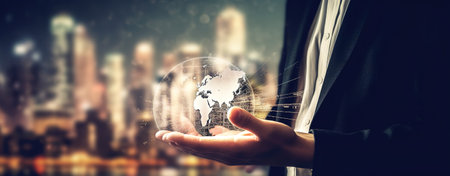 Businessman holding a hologram of planet earth globe. Close up shot. Futuristic AI technology. Generative AIの素材
