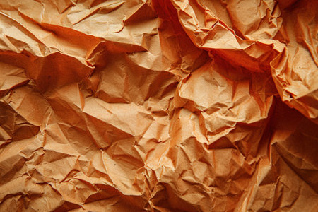 Orange recycled paper crumpled texture backgroundの素材